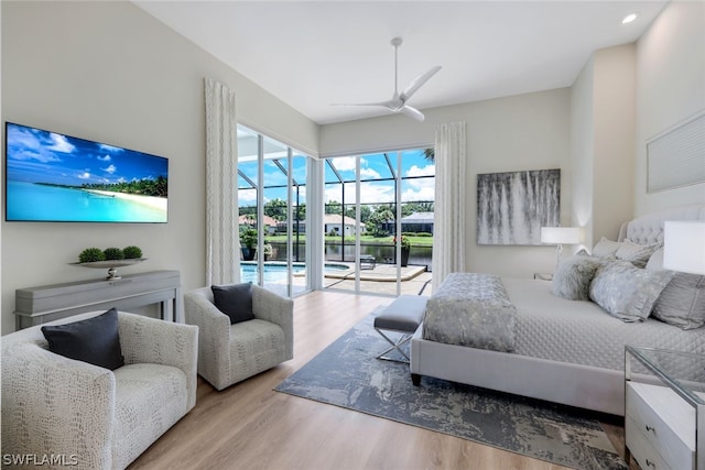 bedroom featuring access to exterior, ceiling fan, and light hardwood / wood-style flooring