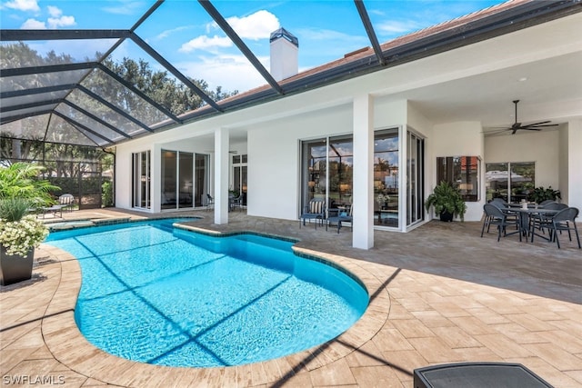 view of swimming pool with ceiling fan, a lanai, and a patio