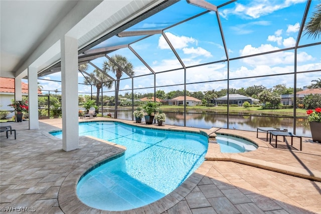 view of swimming pool featuring glass enclosure, a water view, a patio, and an in ground hot tub