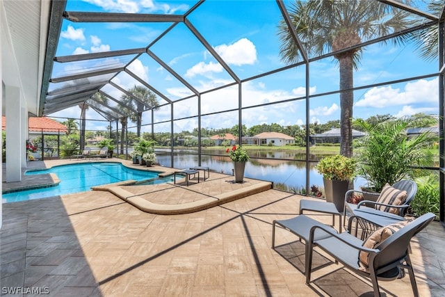 view of swimming pool featuring a lanai, a water view, and a patio area