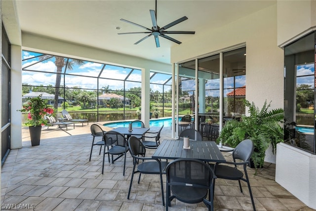 sunroom featuring ceiling fan