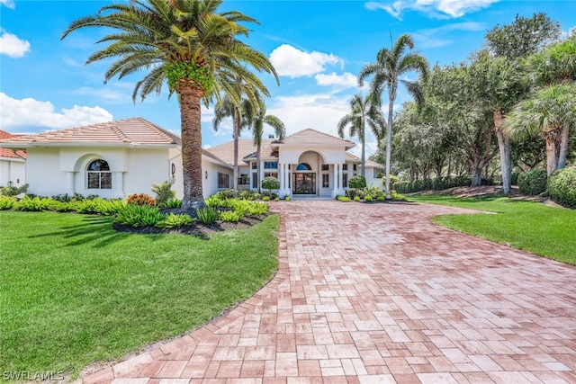 mediterranean / spanish-style house with a front yard