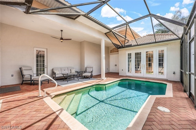 view of pool with a patio, a lanai, french doors, and ceiling fan