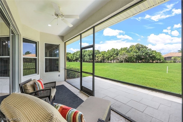 sunroom featuring a ceiling fan