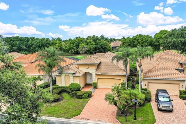 mediterranean / spanish home with a garage and a front yard