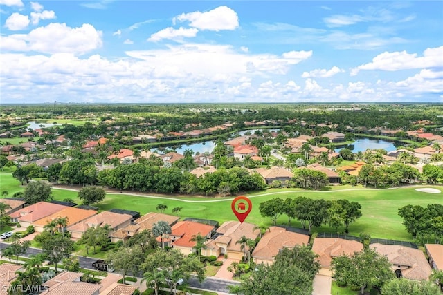 drone / aerial view featuring view of golf course, a water view, and a residential view