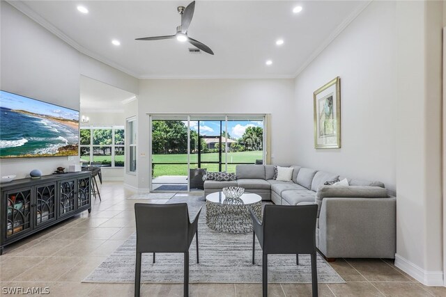 tiled living room with crown molding and ceiling fan