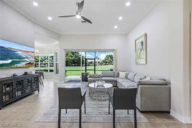 living room with ornamental molding, ceiling fan, and baseboards