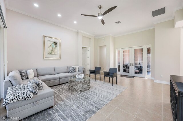 tiled living room featuring crown molding, ceiling fan, and french doors