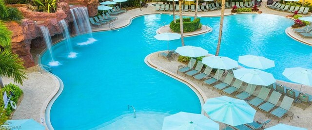 view of swimming pool with pool water feature