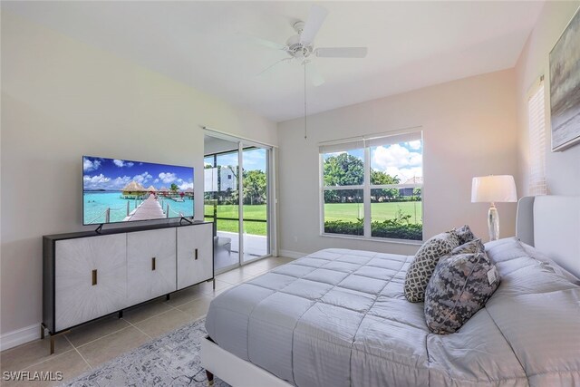 tiled bedroom with multiple windows, access to exterior, and ceiling fan