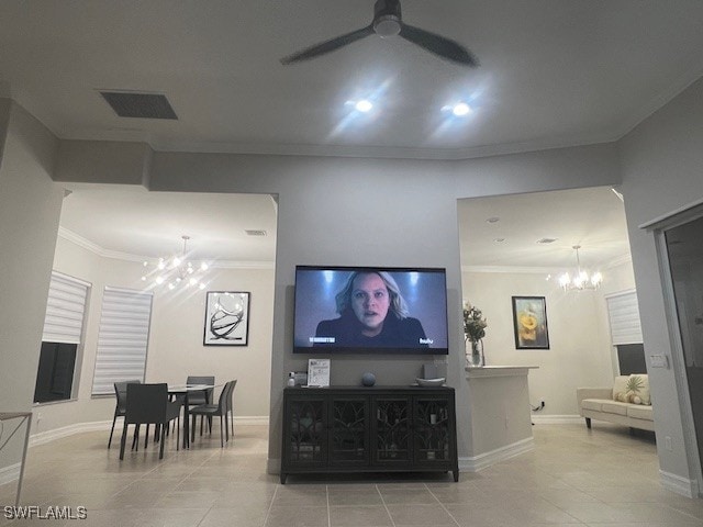 living room with baseboards, visible vents, tile patterned floors, crown molding, and ceiling fan with notable chandelier