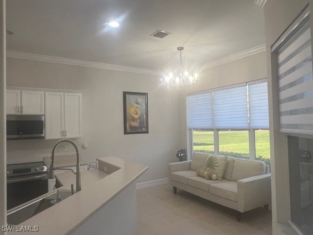 kitchen with white cabinetry, visible vents, stainless steel appliances, and crown molding