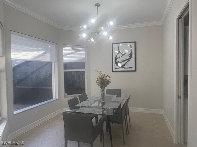 dining area with light tile patterned floors, ornamental molding, a chandelier, and baseboards