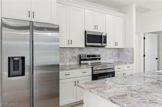 kitchen with backsplash, white cabinetry, and appliances with stainless steel finishes