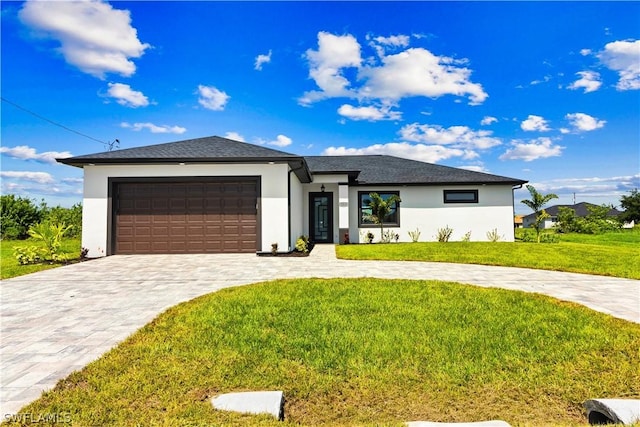 view of front of house featuring a garage and a front lawn