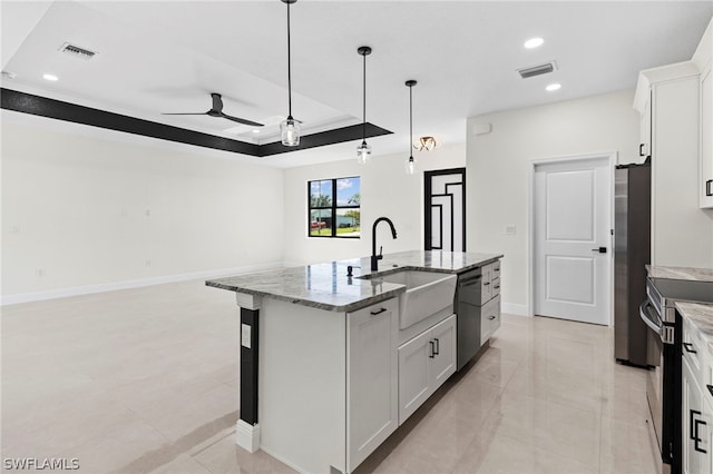 kitchen featuring sink, a kitchen island with sink, white cabinetry, and appliances with stainless steel finishes