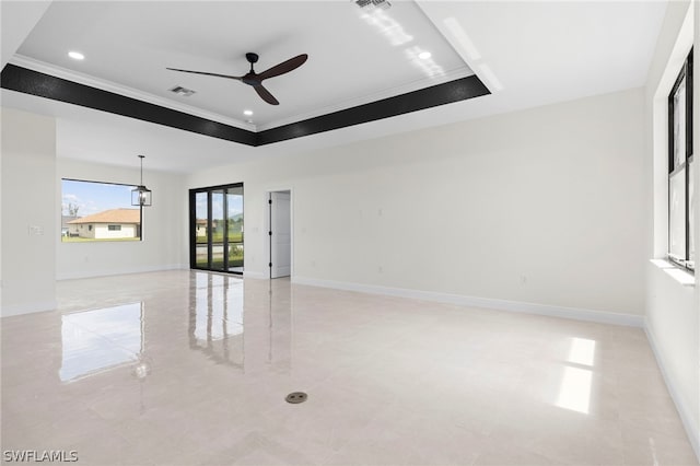 unfurnished room with crown molding, ceiling fan, and a tray ceiling