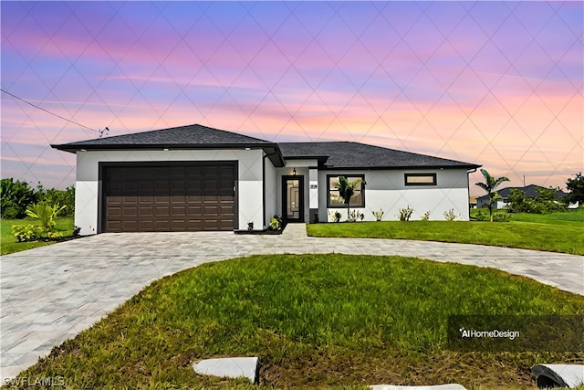 view of front of home with a garage and a yard