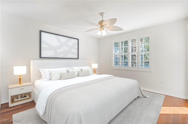 bedroom with hardwood / wood-style floors and ceiling fan