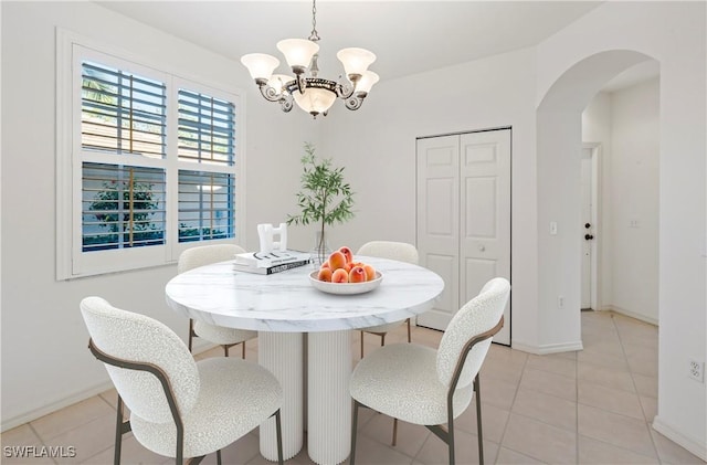 dining room with an inviting chandelier and light tile patterned floors