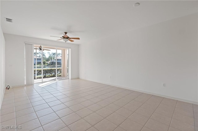 empty room featuring light tile patterned flooring and ceiling fan