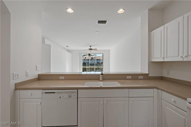 kitchen featuring dishwasher, ceiling fan, sink, white cabinetry, and kitchen peninsula