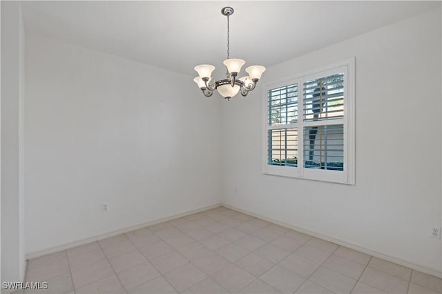 spare room with a chandelier