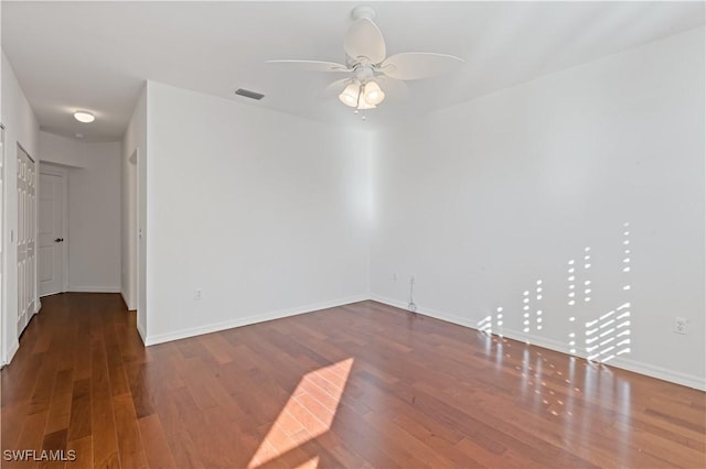 empty room with hardwood / wood-style flooring and ceiling fan