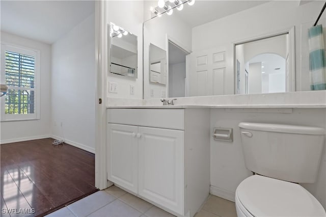 bathroom with vanity, tile patterned flooring, and toilet