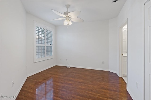 spare room with ceiling fan and dark hardwood / wood-style floors