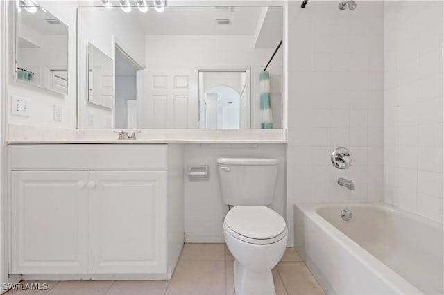 full bathroom featuring vanity, tile patterned flooring, tiled shower / bath, and toilet