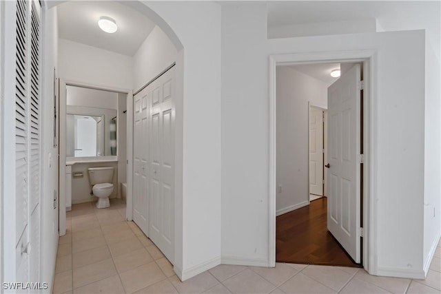 hall featuring light tile patterned floors