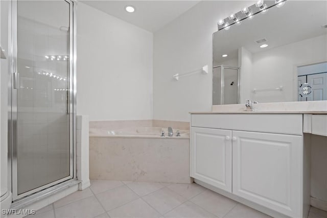 bathroom featuring tile patterned floors, independent shower and bath, and vanity