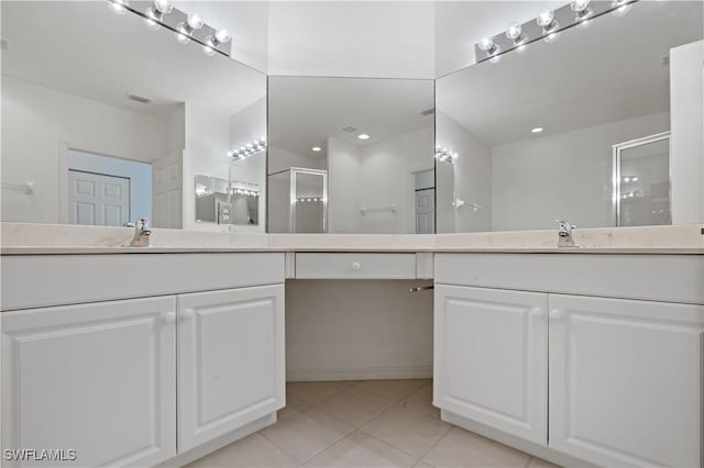 bathroom with vanity, a shower with door, and tile patterned floors