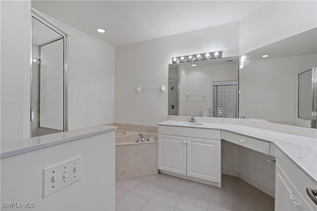 bathroom featuring vanity, tile patterned flooring, and shower with separate bathtub