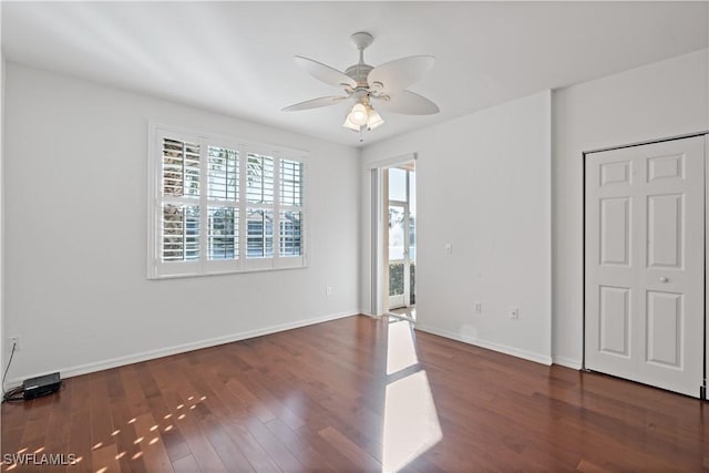 unfurnished bedroom with dark hardwood / wood-style flooring and ceiling fan