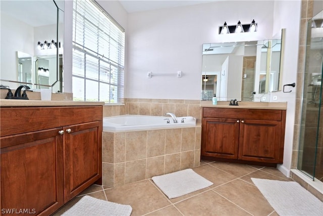 15578 Vallecas Ln, Naples, FL 34110 - bathroom with two vanities, a stall shower, a bath, and tile patterned floors