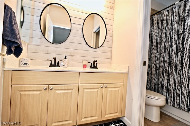 bathroom featuring vanity, toilet, a shower with shower curtain, and wood walls