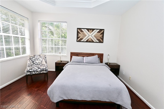 bedroom featuring dark hardwood / wood-style floors and crown molding