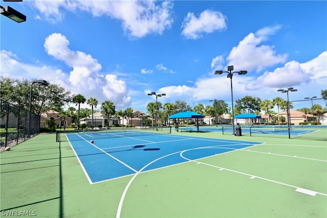 view of tennis court with basketball hoop