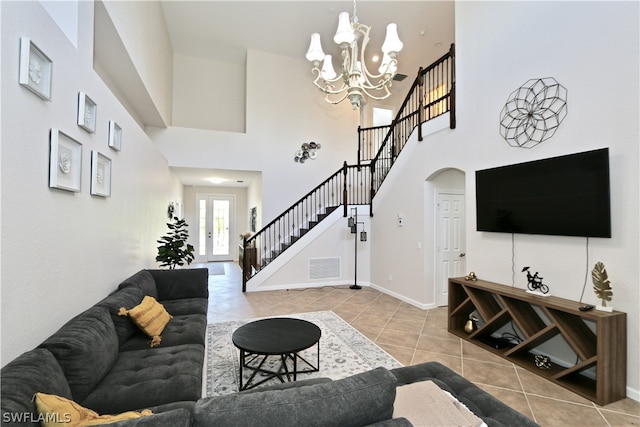 tiled living room with a chandelier and a high ceiling