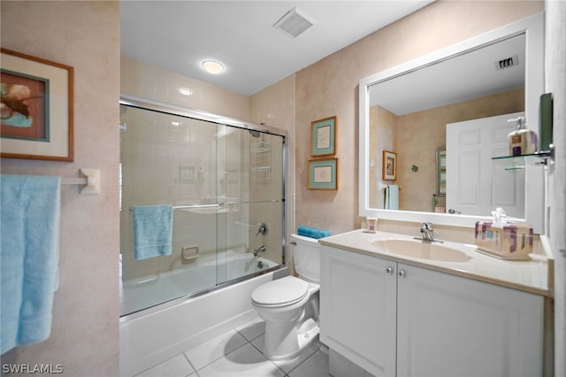 full bathroom featuring bath / shower combo with glass door, vanity, toilet, and tile patterned floors