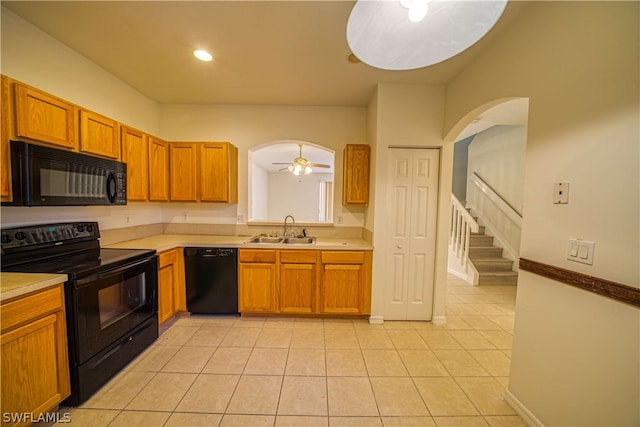 kitchen featuring ceiling fan, sink, light tile patterned flooring, and black appliances