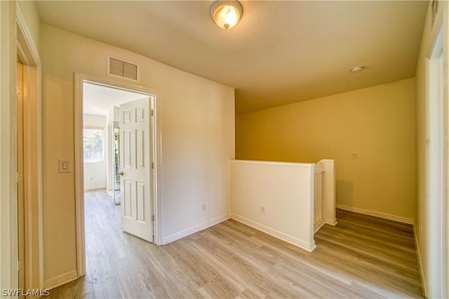 unfurnished room with light hardwood / wood-style floors