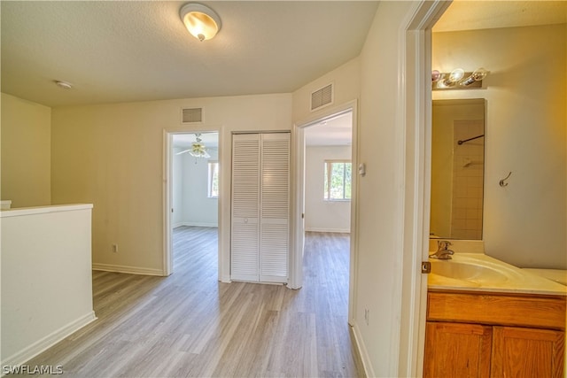 bathroom featuring a textured ceiling, vanity, ceiling fan, a shower, and hardwood / wood-style flooring