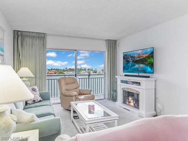 living room with light colored carpet, a textured ceiling, and a high end fireplace