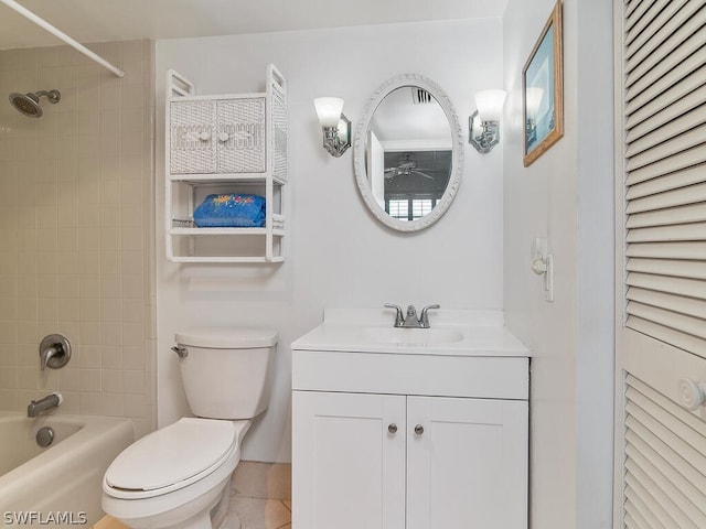 full bathroom featuring vanity, tiled shower / bath combo, and toilet