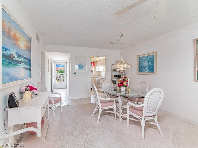 dining space with light tile patterned floors and a textured ceiling