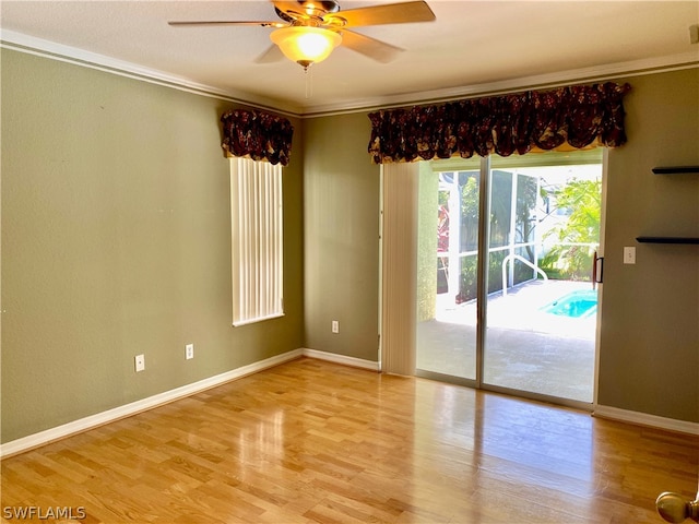 unfurnished room with light hardwood / wood-style flooring, ceiling fan, and crown molding